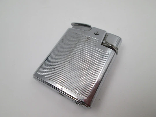 Ronson Varaflame pocket butane lighter. Chromed metal & golden arrowhead. England