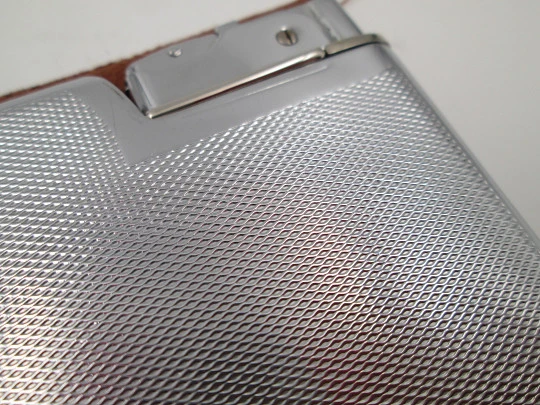 Seigneur cigarette case with petrol lighter. Silver plated metal. Lines and waves motifs