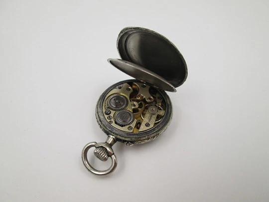 Silver plated open-faced pocket watch. Stem-wind. Porcelain dial. Cherubs motifs. 1890