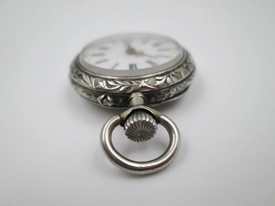 Silver plated open-faced pocket watch. Stem-wind. Porcelain dial. Cherubs motifs. 1890