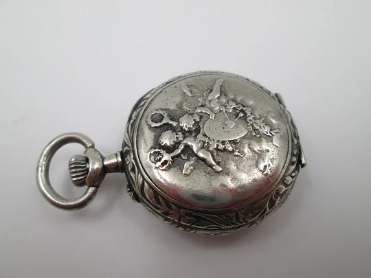 Silver plated open-faced pocket watch. Stem-wind. Porcelain dial. Cherubs motifs. 1890