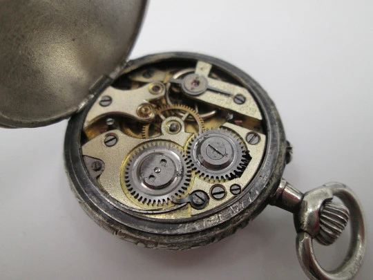 Silver plated open-faced pocket watch. Stem-wind. Porcelain dial. Cherubs motifs. 1890