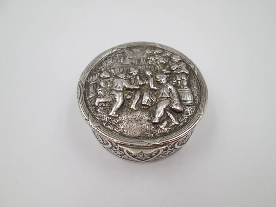 Table pillbox. Sterling silver and vermeil. High relief celebration scene. 1960's. Europe