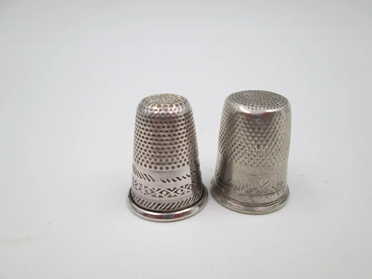 Two sewing thimbles. Sterling silver. Geometric motifs and cross. Spain. 1970's