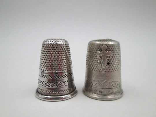 Two sewing thimbles. Sterling silver. Geometric motifs and cross. Spain. 1970's