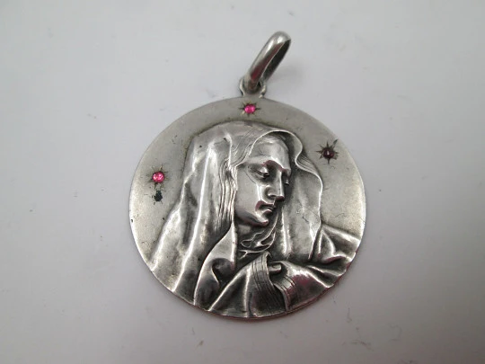 Virgin Mary medal. Silver plated metal. Stars with violet stones. Ring on top. Europe. 1960's