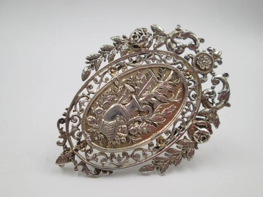 Women's brooch. Bitone plated metal. Flowered openwork edge. Pitcher & basket