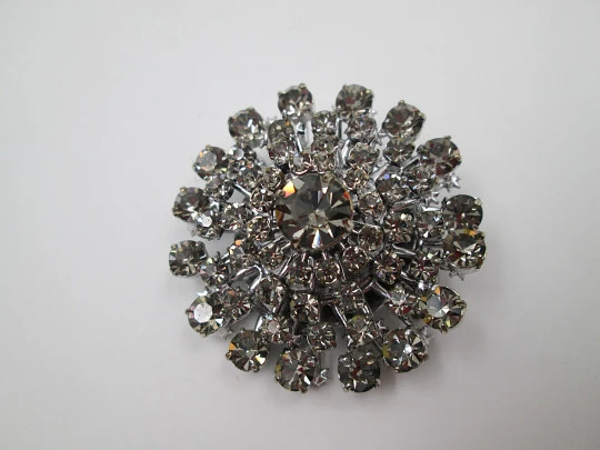 Women's brooch. Silver plated metal. White faceted gems. United States. 1970's