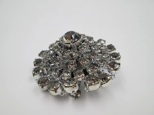 Women's brooch. Silver plated metal. White faceted gems. United States. 1970's