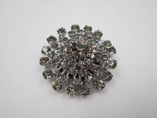 Women's brooch. Silver plated metal. White faceted gems. United States. 1970's