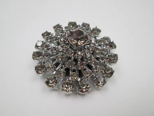 Women's brooch. Silver plated metal. White faceted gems. United States. 1970's