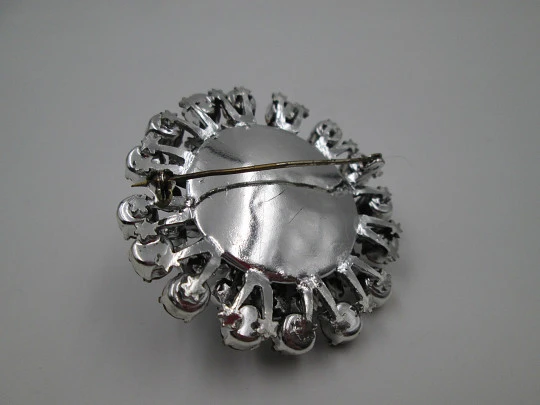 Women's brooch. Silver plated metal. White faceted gems. United States. 1970's