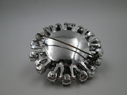 Women's brooch. Silver plated metal. White faceted gems. United States. 1970's