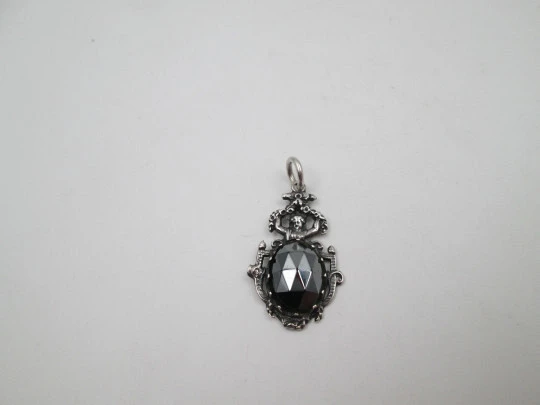 Women's sterling silver pendant. Cherub and faceted black gem. Ring on top. Europe. 1980's