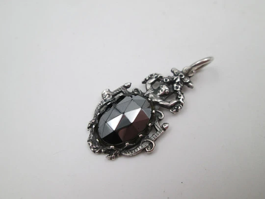 Women's sterling silver pendant. Cherub and faceted black gem. Ring on top. Europe. 1980's